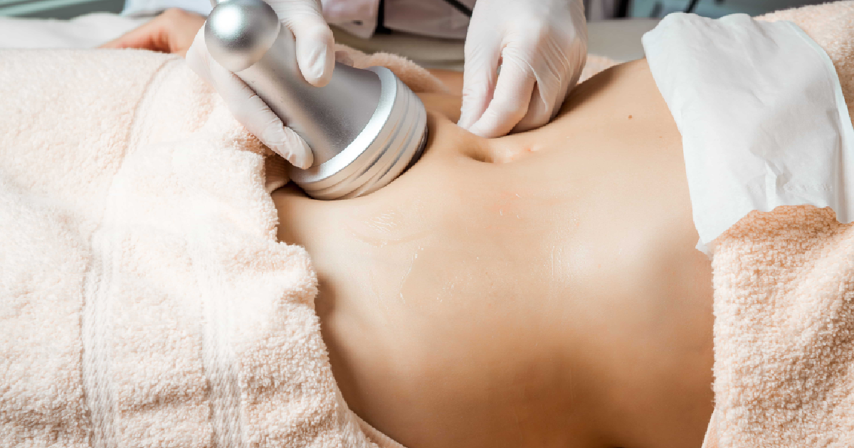 Body contouring treatment on abdomen with handheld device in Scottsdale, AZ